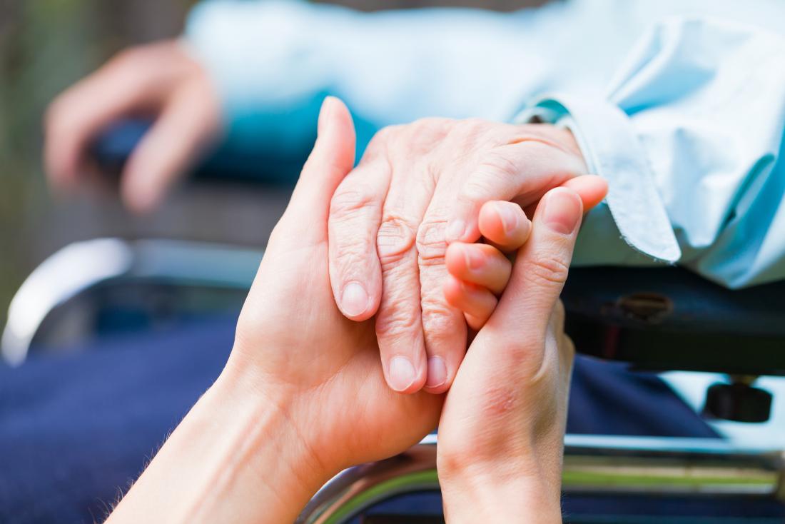 a-person-in-a-wheelchair-holding-hands