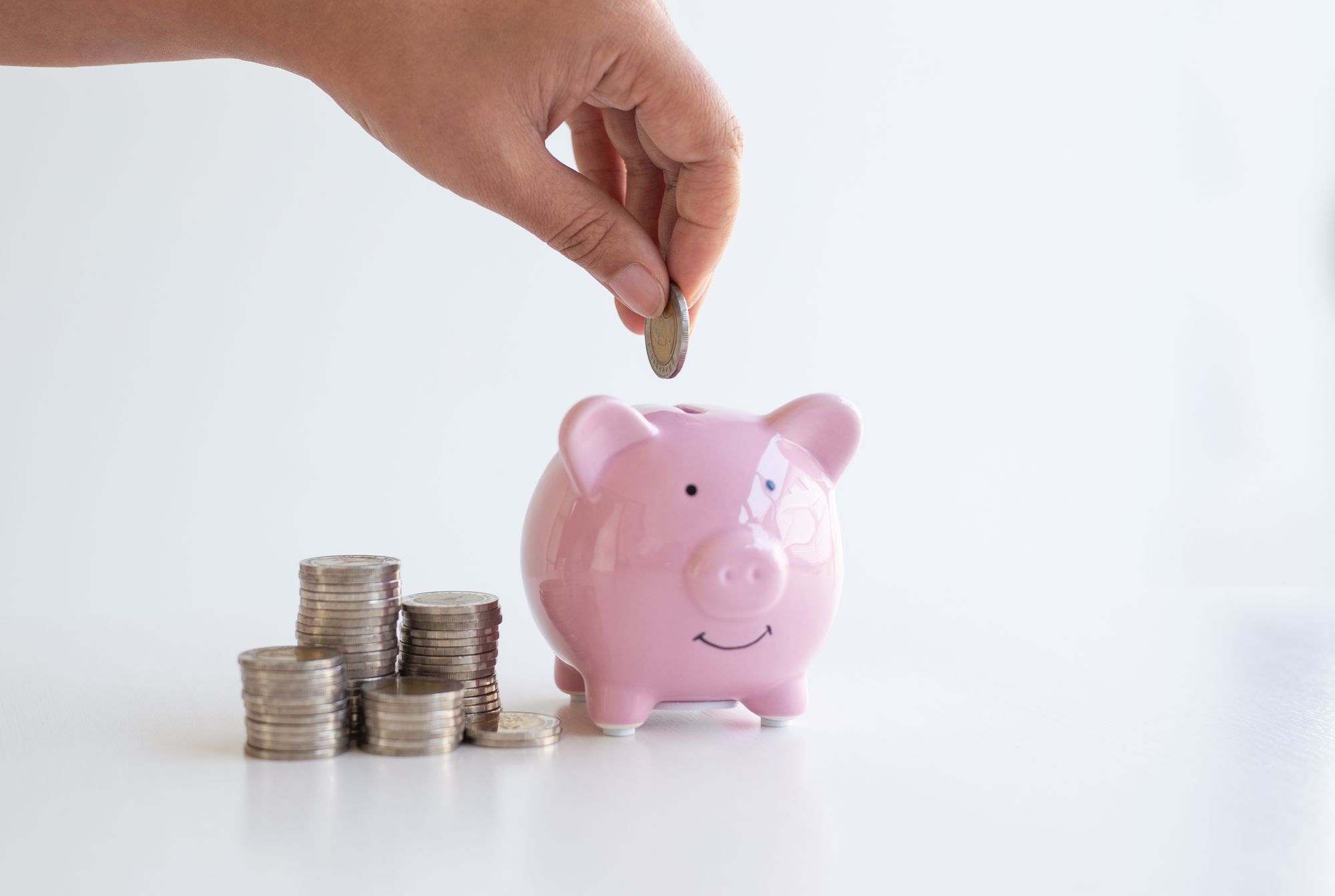 Putting coins in a piggy bank during repetitive task practice.