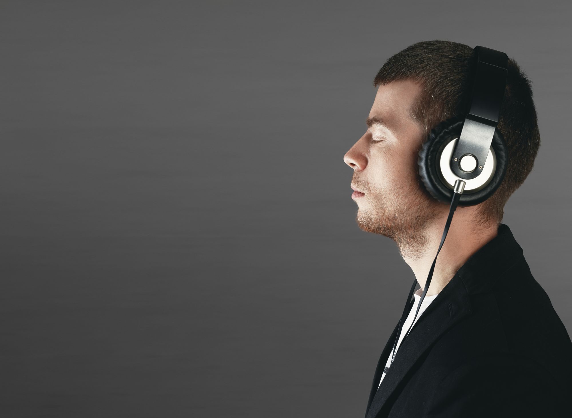 Man in headphones listening to mental practice recordings.